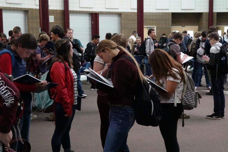 BOOKING+IT%3A+Students+gather+around+the+school+to+sign+each+other%27s+yearbooks.+Students+received+their+book+on+Tues%2C+May+21+after+the+awards+assembly.