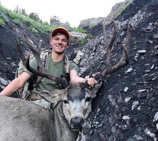 HIKIN HILLS: Sophomore Greg Brown put on plenty of miles to get this buck, but it was well worth it. 