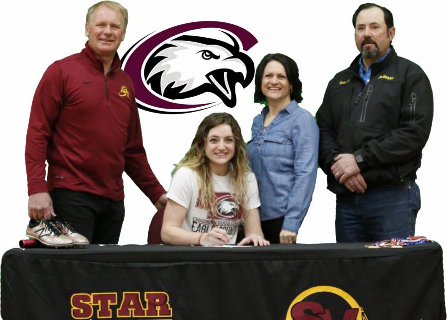 COMMITTED: Hannah Christie poses with her parents and jumping coach Ballard Johnson Feb 25th after signing a letter of intent with Chadron State for track. 