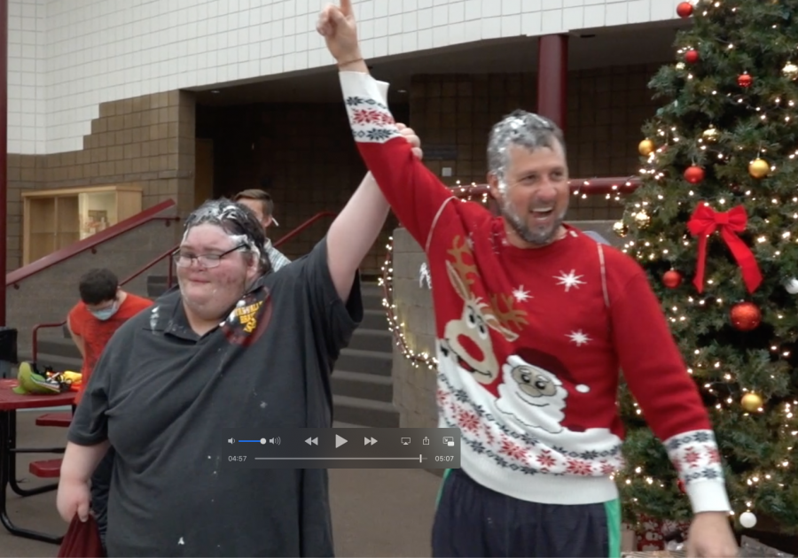 VICTORY: Mr. Frazier joins senior Chance Williams and mistakenly holds up one finger. Two fingers would have more accurately reflected his effort as Frazier lost the pre-Christmas bikie race through the building to Williams. 