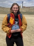 LONG SHOT: Emily Gertsch poses with the discus she threw earlier in the day for a school record. 117 1.5.