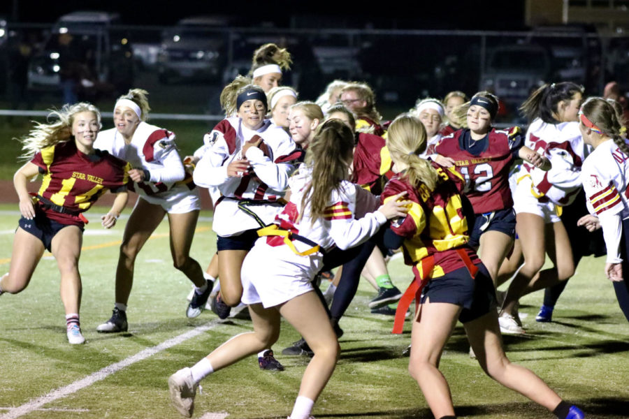 RED ZONE:
Juniors attempt to move the ball down the field to score against the seniors in the Powderpuff game.
The seniors won the game 13-12.
The hardest thing was getting up at six in the morning to go to a freaking cold practice, said junior Delsa Thomas.