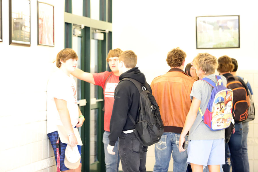 PASSING TIME: Students socialize in the hall between classes. The school has been on the AB block schedule since it moved to the new building 24 years ago. However, change may be in the air next school year.