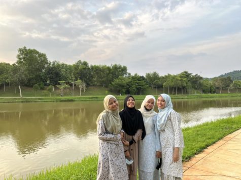 BACK HOME: Iman and her friends stand in front of a river back home in Malaysia. I like to be called Iman, but my full name is Syarifah Nur Iman Alattas binti Syed Mokhsein. I am from Malaysia. I am here under the YES (Youth Exchange and Study) Program. For the picture description, from the left there is me and my friends (Sharifah, Farah and Umairah) wearing Baju Kurung, said Syed.