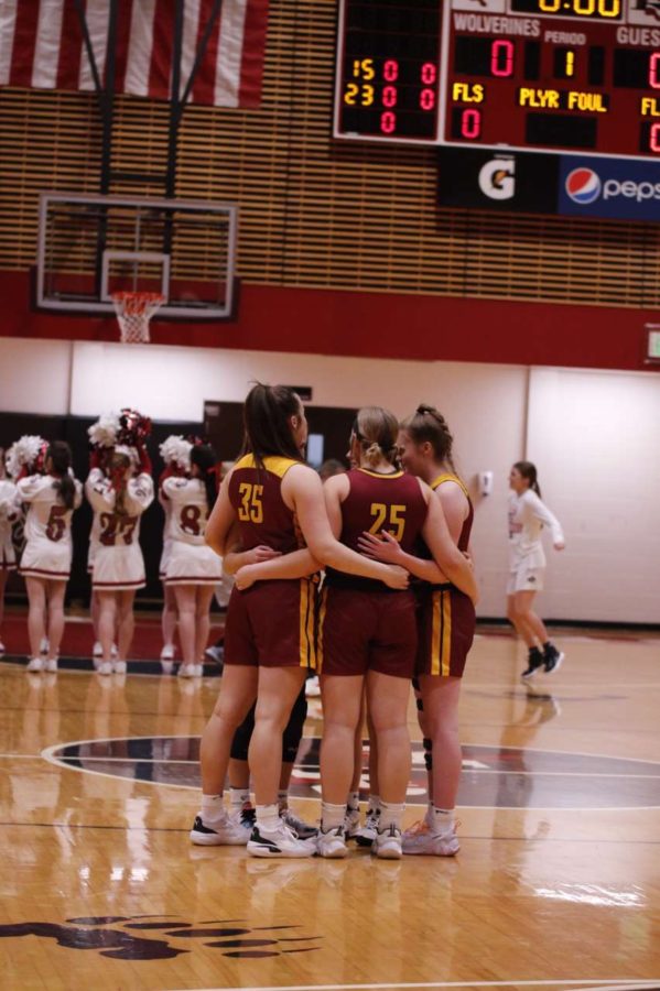 LADY BRAVES: The Lady Braves huddle up before the game starts to give some more motivation. They won this game against Riverton. It was so fun to play this last season with my best friends, said senior Mckenna Frazier.