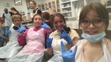 STIFFS: Seniors Mason Brown, Mia Hutchinson, Kimberly Choma, and Rebeckah Bowman pose for a selfie in their lab clothes right before entering the cadaver lab. The cadaver lab focused on teaching and showing students the anatomy of the human body by using cadavers donated to science. Honestly, going to the cadaver lab was the coolest experience of my life. It was really a once in a lifetime opportunity, said senior Rebeckah Bowman.