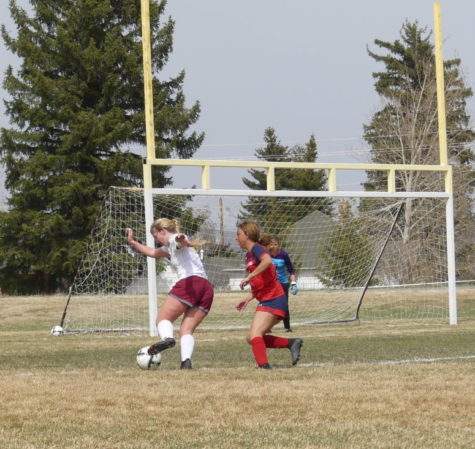 GOAL DRIVEN: Senior Sharon England takes the ball past an Evanston defender to the net. England recently signed to play soccer at Western Wyoming Community College.