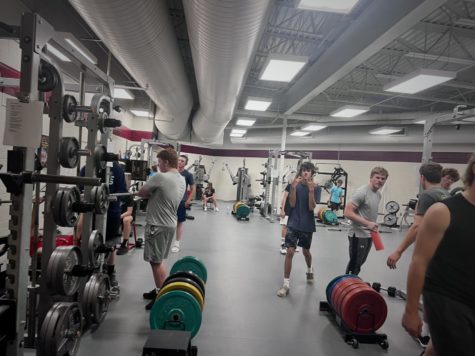 IRON MEN: Students in work hard in weights to get stronger. Weights is one of the most popular electives on the schedule. You can hangout with friends and build muscle, said Sawyer Woolwine..