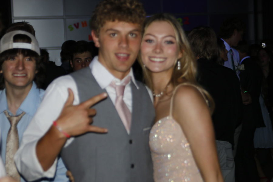 LOVE BIRDS: Seniors Chase Stewart and Aislyn Ivie cuddle up for a picture at the dance. I liked being able to dance with my friends and take pictures on my disposable camera. If I were to do anything differently, I would have definitely planned ahead better for our day date, said Ivie. 