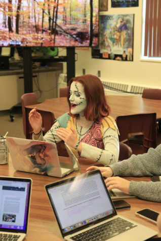 THE NIGHTMARE BEFORE SCHOOL: Addie Waldron talks with her table partners during a work day in English. Waldron said that her claim to fame is the fact that she didnt use face paint in her costume; she colored her face using makeup. Waldron said that the inspiration for her costume was based off of her favorite movie. I have loved The Nightmare Before Christmas since I was a little kid. It is, like ,my favorite Disney movie, and I have always wanted to be Sally. 