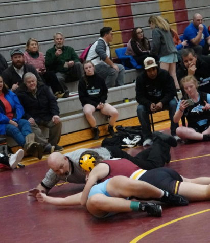 BACK TO MAT: Brooke Schwabs tries to get a pin in the first match of her high school career. Freshman Schwab loves to go to cross fit everyday before school. I wanted to try something new and learn a new skill, said Schwab about her decision to join the new Lady Braves wrestling team.