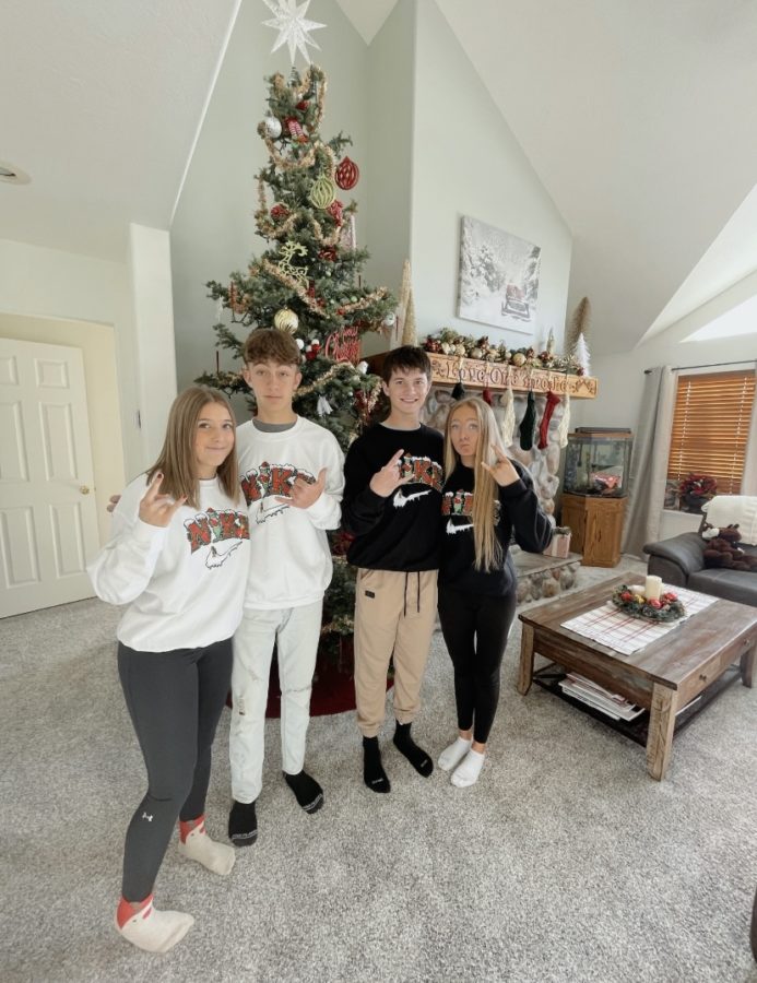 NIKE: A group of juniors model their matching Christmas Nike crewnecks. Junior Aubree Hale said, It is a super cute hoodie, and I had a ton of fun wearing it with Daxton on our day date. I will definitely keep wearing it during the Christmas season.
