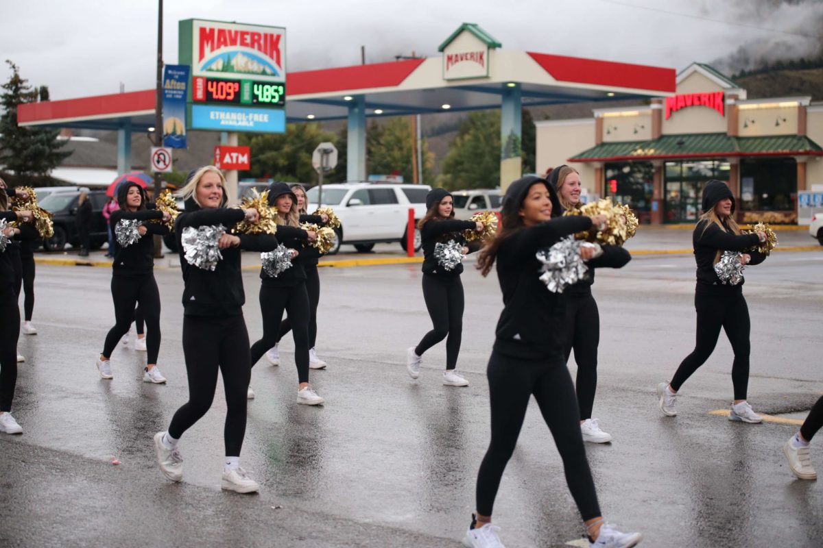 MAIN STREET: Brave Cadettes Leah Penny, Shyann Hoopes, Kumari McCormick, and Nori Christensen join their teammates in marching during the homecoming parade. It was really cold, but it was fun being with my teammates, said Hoopes. 