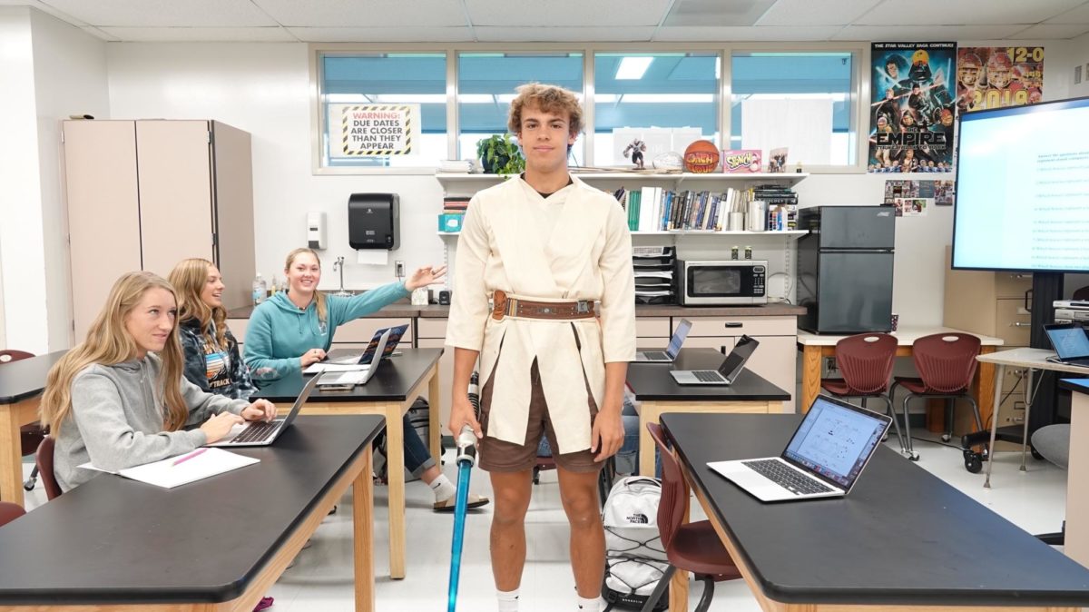 JUNIOR JEDI: Junior Hayden Morgan channels his inner-ObiWan Kenobi during the Star Wars dress up day of homecoming week. Many students donned such costumes to celebrate the day and have fun. I had to fight the Dark Side because Dayton (Schwab) and Prescott (Viegel) were dressed up as Darth Vader and Kylo Ren. 