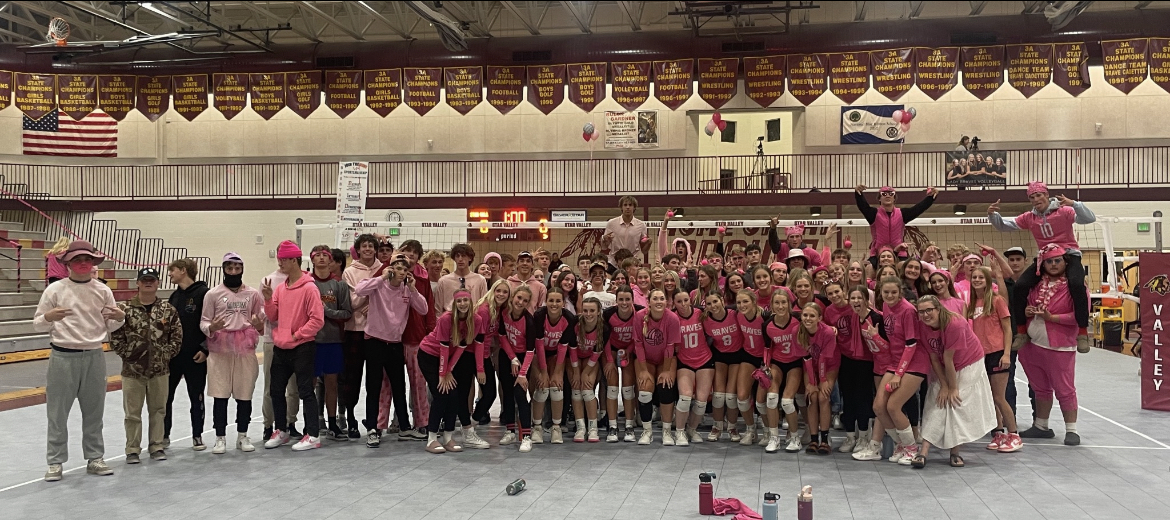 PINK POWER: The student section gathers to take a picture after the volleyball girls took the dub against Jackson. Senior Kenlee Engelhardt said, Having the student section there really brings up my energy and makes me want to play good. 