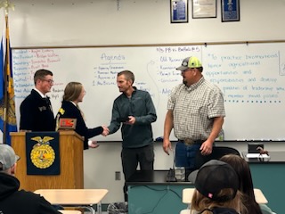BUCKLE UP: Representatives from Simplot present FFA officers with belt buckles. The silver and turquoise buckles show recognition for the hard work and responsibility of the FFA officers.