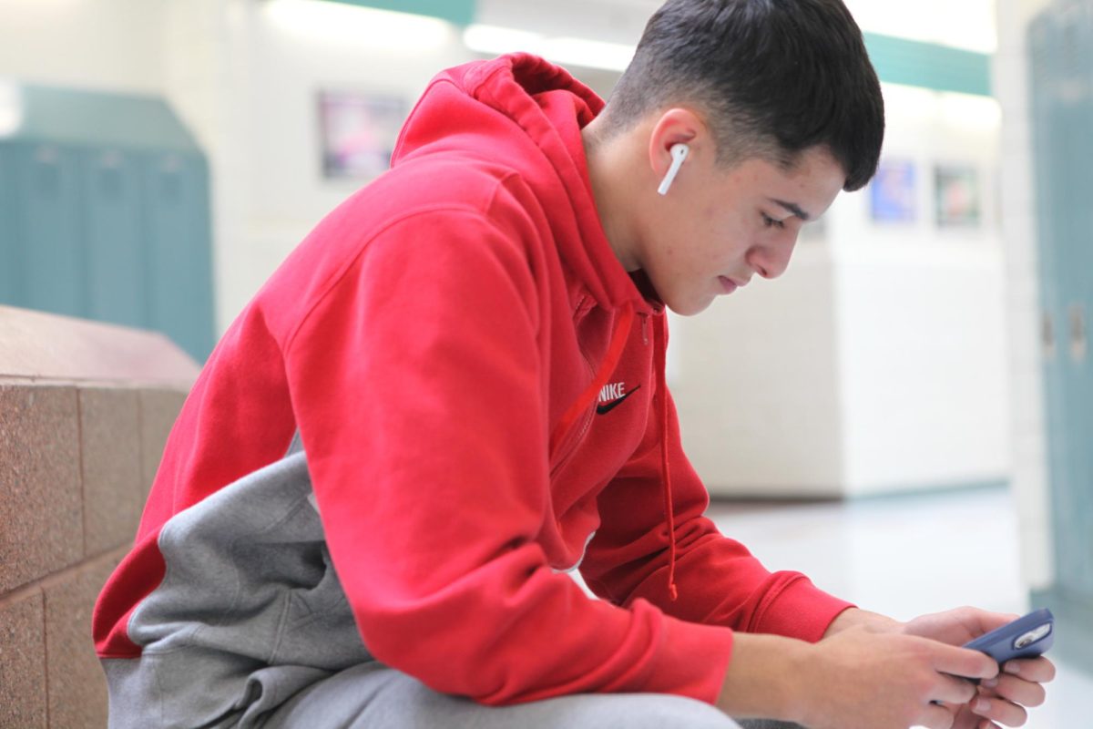 DIGITAL DISCOVERY: Miguel Gallego Mena sits in the hallways, immersed in his phone. He was delving into a world of Twitch during a brief break from his class. I just need a tiny break from class from time to time, to rest my mind, Gallego said.