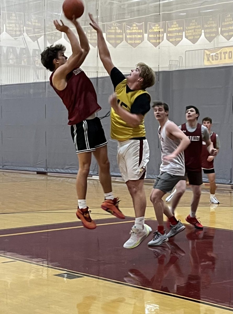 RISE UP: Will Linford goes up for a shot over Big Country Lawson during practice. Six varsity players will return this season for the Braves. Will bricked it off the backboard because I am a hall of fame  intimidator, said Lawson.
