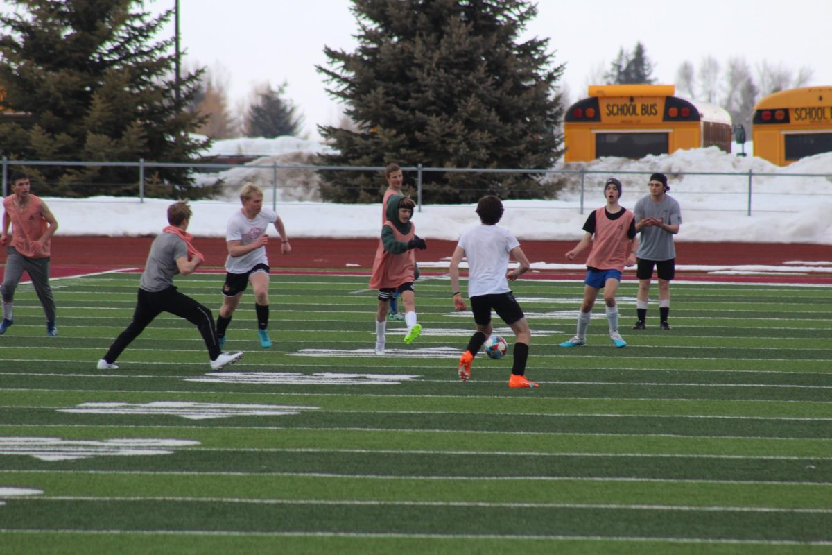 FOOTLOOSE: Freshman Carter Bagley passes the ball through heavy traffic. Carter is one of only a few freshman on the boys soccer team. Its going pretty well. Practice is well-rounded and the conditioning is hard but worth it, said Bagley.