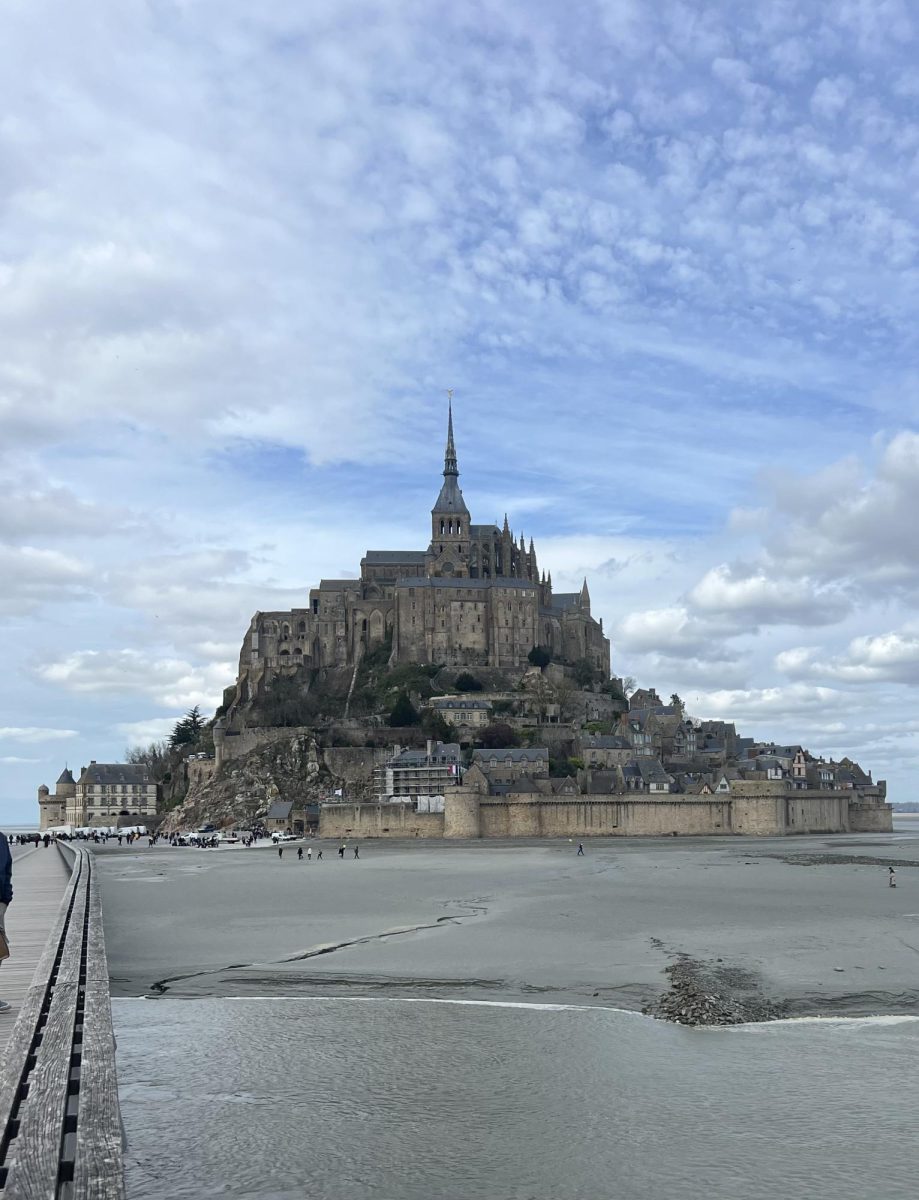 FAIRYTALE: While visiting Europe over spring break with the school group, senior Chelsea Hoopes stops to take a picture of the Mont St. Michel Castle in Normandy, France. Hoopes loved visiting France during the trip, and it was a very cool experience for her. The Mont St. Michel Castle in Normandy, France was sort of a place out of a fairytale, and it was so cool to walk around the castle and go to the souvenir shops and food shops! Hoopes said.