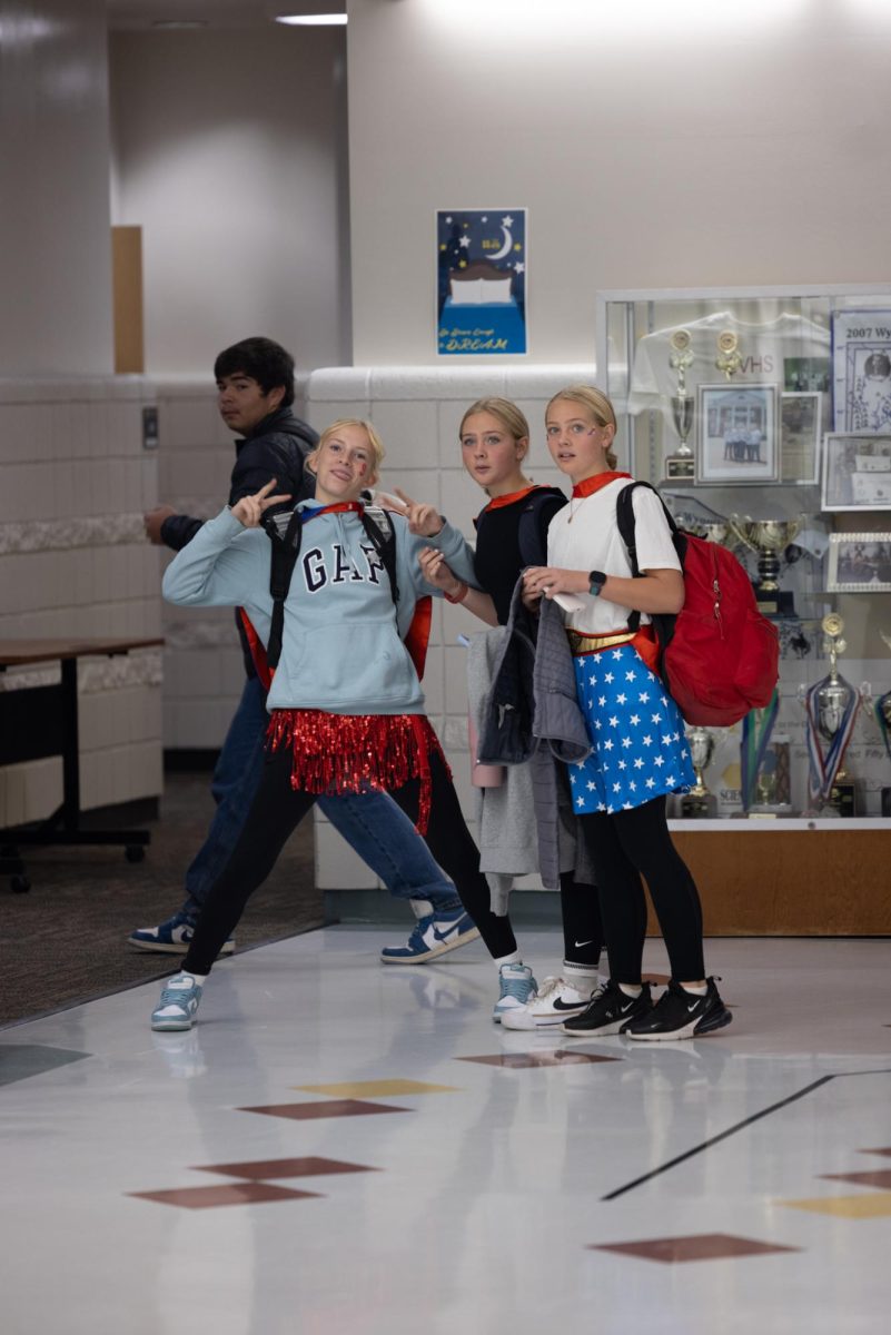 TRIO: The Dunn twins Kellsie and Gracie join Rachel Smith as different versions of Wonder Woman. These freshmen were amongst the many who dressed up for Halloween. "I was very happy that someone wanted to take our photo to show off our costumes," said Smith. 