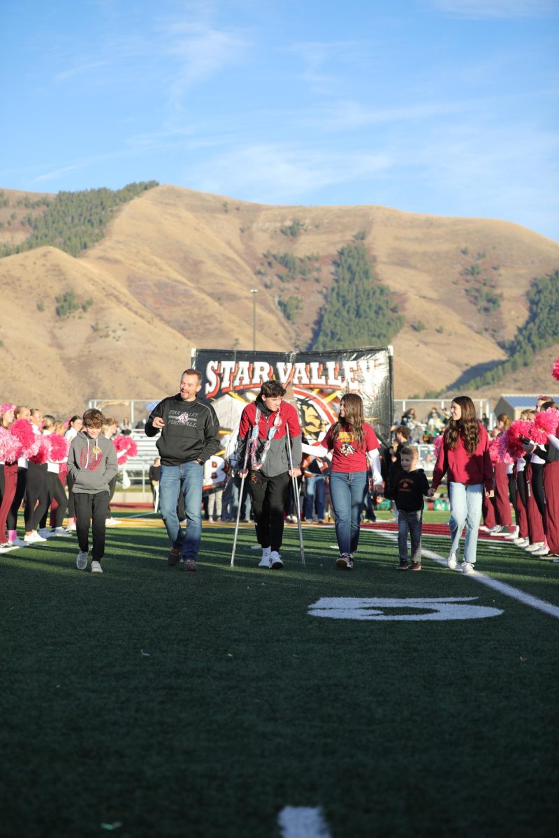 Dayton Schwab limps down the field for senior night with his family. Schwab said, "I'm sad I couldn't play the last half of the year, but it was nice to be by my teammates' side." Schwab stood motionless in the victory formation for the last play of the state championship game.  