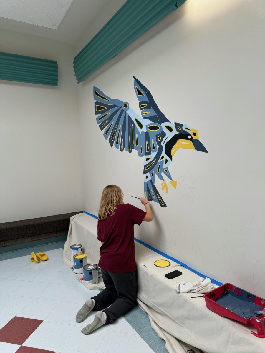 Artist Emily Call works on a new hall mural. Call put together this mural for her senior project and invested more than 20 hours into the painting. Call said, "Despite these challenges, watching the mural come to life on the wall made every effort worthwhile."