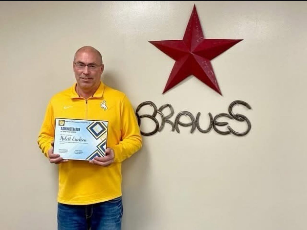 Activities Director Robert Erickson stands with his award for Wyoming Theater Administrator of the Year. Drama coach and musical director Tami Nielsen nominated Erickson for the honor. "I was honored to receive the award. I hope that all kids and coaches in all programs feel like I am interested in their success and feel supported in their efforts,"  said Erickson.