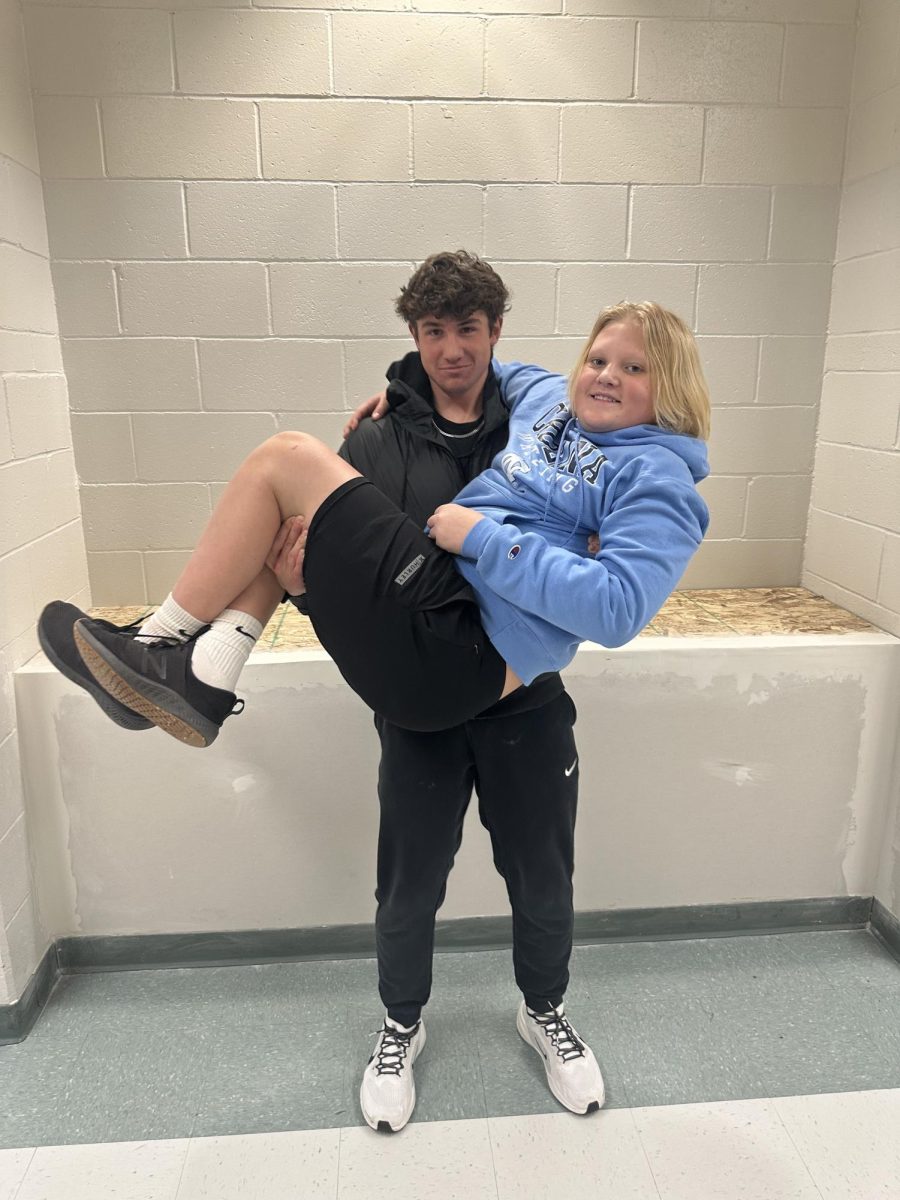 "Always ask for help if you need it and turn in assignments on time," said Paxton Beebe who shows his support for freshmen by hoisting Kingston McNaughton in weights class.