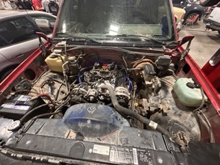 Students learn how to rebuild and replace engines on school-owned practice vehicles like this red Chevy. The school has several such cars for students to work on. 