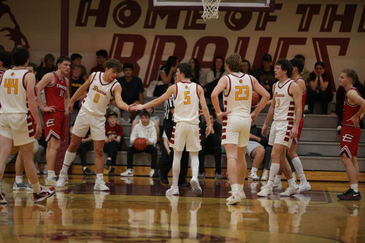 Junior Will Linford dabs up junior Dylan Shumway after a free throw against Evanston. Star Valley looked to get their revenge on Evanston for their prior lost to them in the pre season. Junior Will Linford said, " All week at practice we went over Evanston's style of playing,  so we knew their tendencies. We just played ball and we came out with a win."