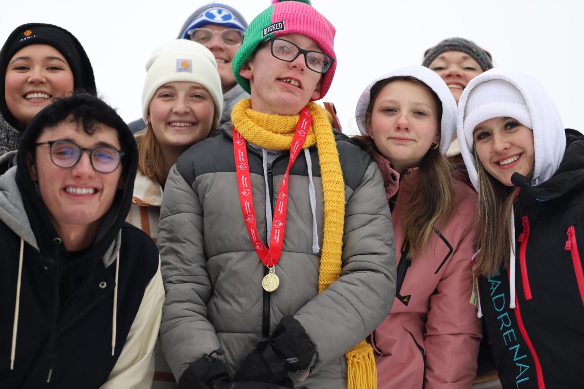 One of the 2025 Special Olympic medalist, Jade Waldron poses with family and friends. They also had volunteers there to take photos of the athletes, and Engel and Volkers had a tent with hot chocolate and water that they gave out to athletes and everyone who needed it. Waldron exclaimed, "I love cheering for my friends while they are racing, and I love all the family and friends who are there to support me."