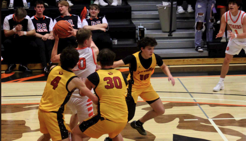 Smith Mclure, Dayton Schwab and Cooper Lawson double team Rock Springs' Lionburger. The Tiger big man stands at six foot six inches tall. "He was tall, but not too hard to move around," said Lawson.