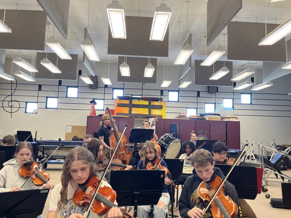 The concert orchestra practices one of the songs that they will play at String-Fest. Conductor Lisa Barber said, "We are working hard in orchestra to learn the music. When we arrive at Stringfest on March 19, we only have that day to rehearse with the students from Jackson and be able to play together as an orchestra for a concert that night, so it's important that we know the music well when we arrive." The orchestra has been working hard for the past 2 weeks to prepare for their first ever high school String-Fest.