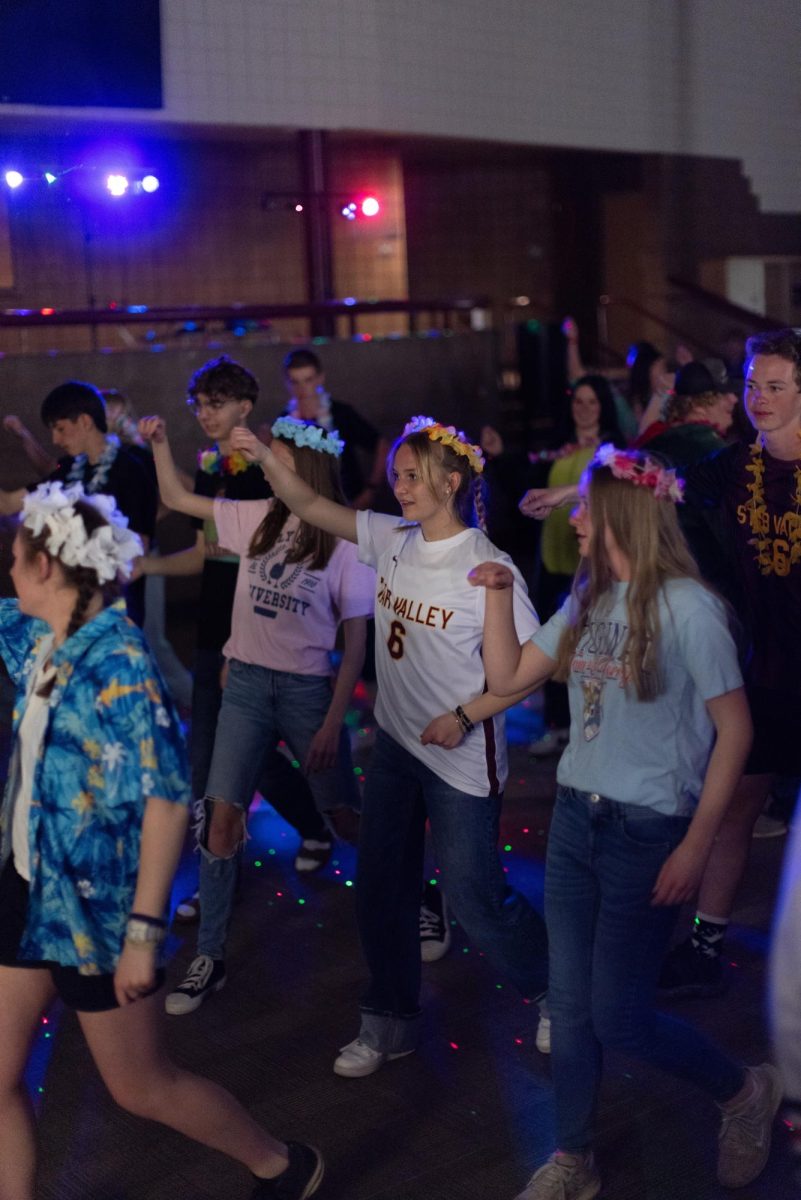 Students join a line dance. Madison Strgar, "My favorite thing that happened at the dance was the two swing dance songs that were played." 
