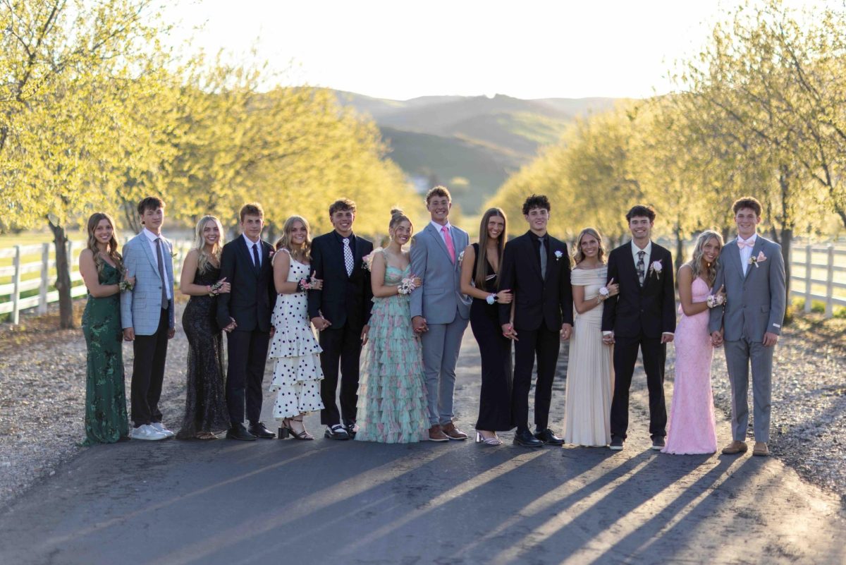 A group of 14 prom goers take pictures in Fairview. Earlier in the day this group battled each other in paintball. "Definitely not what I expected, but it ended up being fun, minus the bruises," said Travis Thomson.