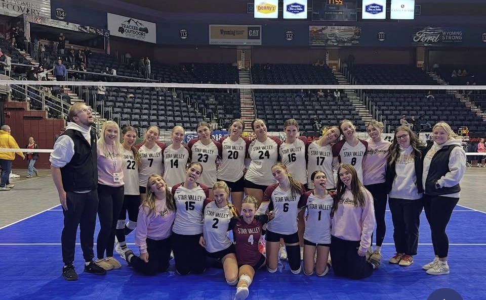 The Lady Braves volleyball team takes a picture after their last game of the season. Senior Addy Christiansen  was the highest scoring player during the game. The team has a stuffed chicken named Baldrick who has given them good luck throughout state and this season and has been with them through the entire season.
