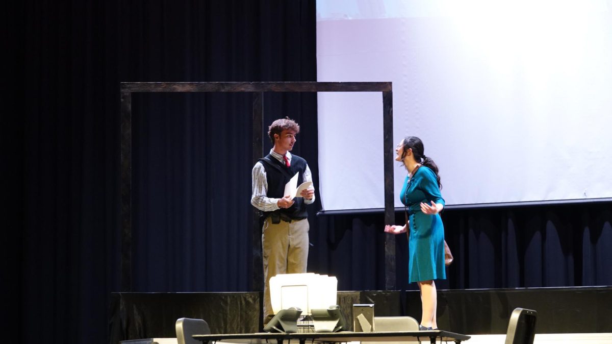 (Left to right) Senior Porter Ludwig and junior Maya Mavy act their parts in "Hole in the Sky." Portraying an argument between a couple before the tower was hit, many people thought it was just going to be another normal day, not knowing it would change their lives forever.