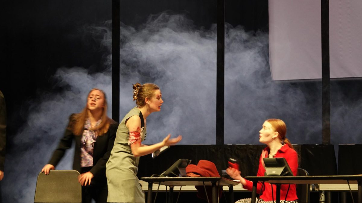 (Left to right) Sophomore Zanna Engler with seniors Mary Johnson and Kimber Aitken. Workers try to get out of the falling building. "I love the remembrance that it brought to this generation and the reminder that it is—how much 9/11 had an impact on this century and how it affected individual lives of those in that building," said senior Caleb Erickson.