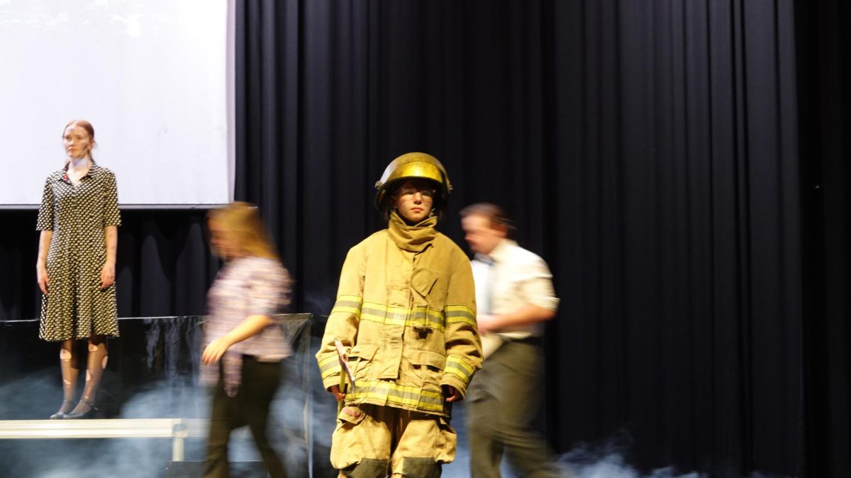(Left to right) Senior Mary Johnson, sophomore Zanna Engler, senior Abigail England, and sophomore Will Hinton on stage. Firefighters respond to the tower being hit. This tragic event united citizens of the United States of America more than any other event in the recent history of the United States.