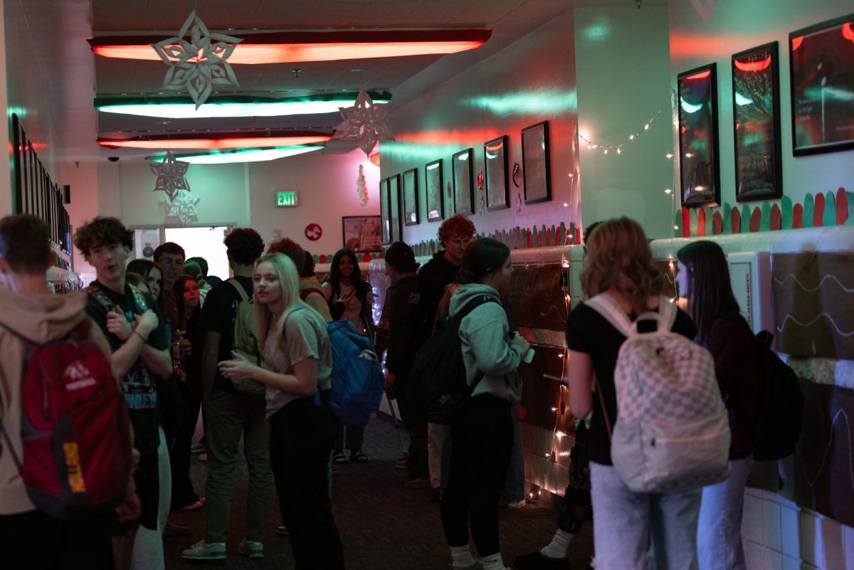 Students chat while admiring the Gingerbread-like scenery. Juniors carved out gingerbread arches and lined the wall with gumdrops and icing way past sunset. Raiden Haderlie shares his experience with decorating his hall: “I was in charge of getting people to come decorate which was hard at first then more and more people kept coming, it was fun because we were able to make a couple ideas come to life and made a sick entrance with sick lights and took the dub.”