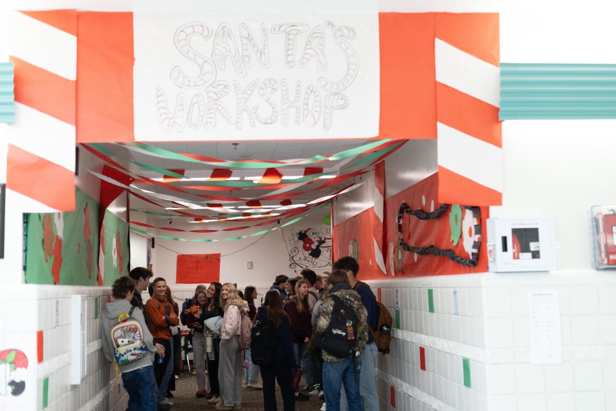 Students gather and talk as they wait to go into English class surrounded by scenes of Santa's workshop. Many Juniors stayed well beyond school hours to finish the decorations including Joe McGee who comments, “I was at the school till like 10:30 one night and the next day I showed up an hour early to hang up lights that I brought from my own house.”

