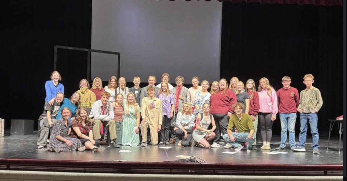 Drama Team Heads to State With “Hole in the Sky”. Cast and crew pose onstage before departing for the state drama competition, showcasing the full company behind the 9/11 one-act performance. The production’s state-bound team included 34 dedicated students, representing acting, tech, costumes, and design.