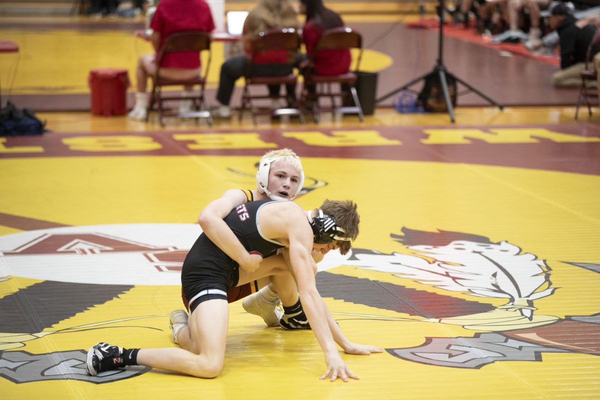 Sophomore Nolan Hyde tries to overthrow his opponent during the Braves Braw. "The thing that I love about wrestling is spending time with teammates between matches," he said. 