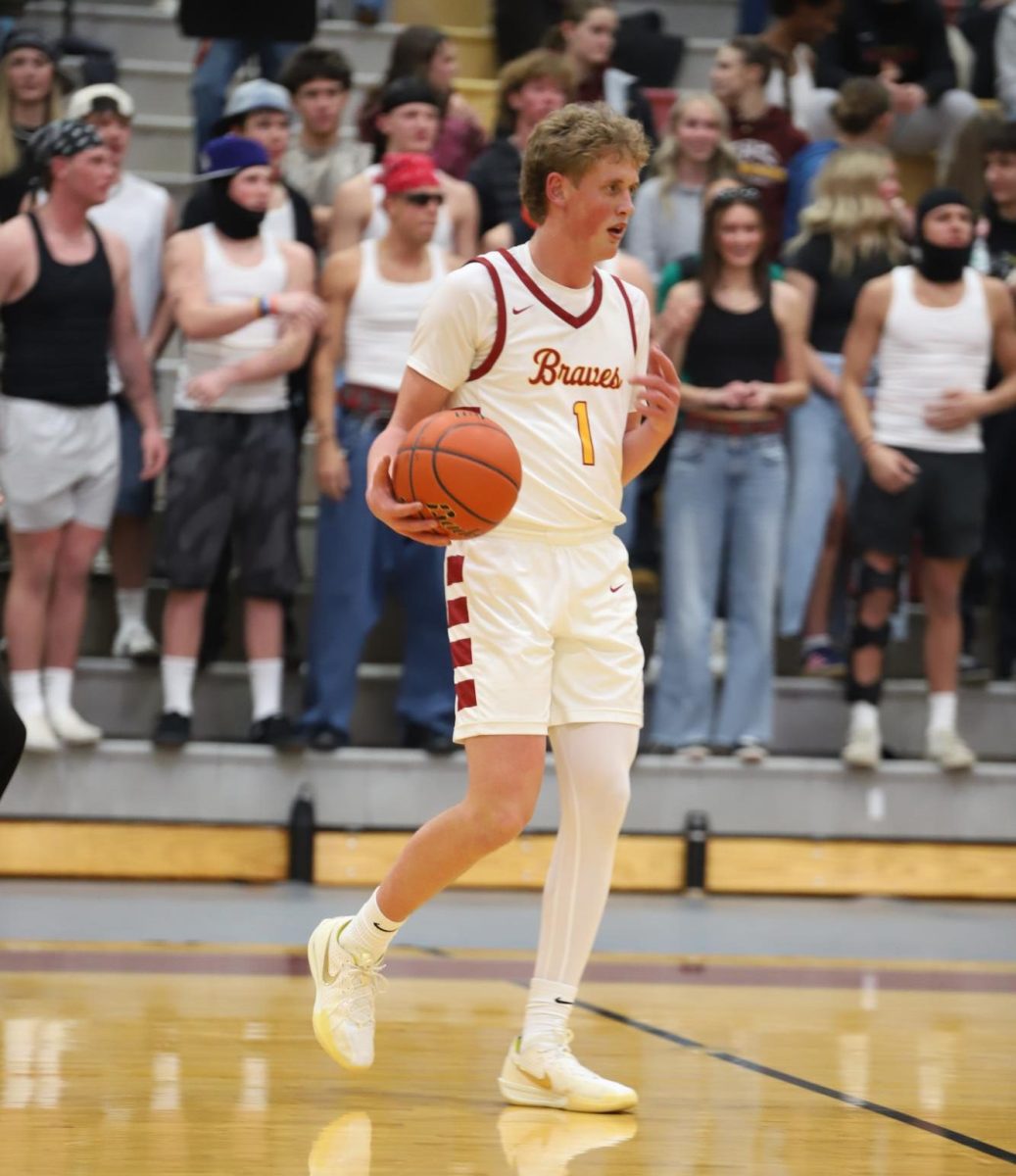 Senior Cooper Lancaster brings the ball down the court with confidence and control, setting up the offense as the team looks to continue its momentum. Varsity coach Matt Shumway said, “I think the boys have played really well over the last couple of weeks. We have won 4 in a row and a lot of that is due to our execution on offense and playing more connected on defense.” The boys have been playing with more energy and focus in recent games, showing improvement on both ends of the floor as they work together and trust one another.




