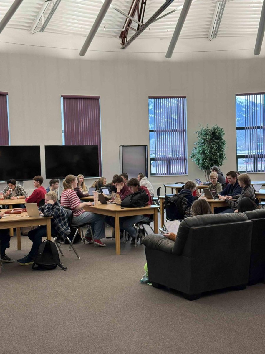 Students chill in the library media center before schools starts. The library is a go-to place for students needing a safe, comfortable hang.