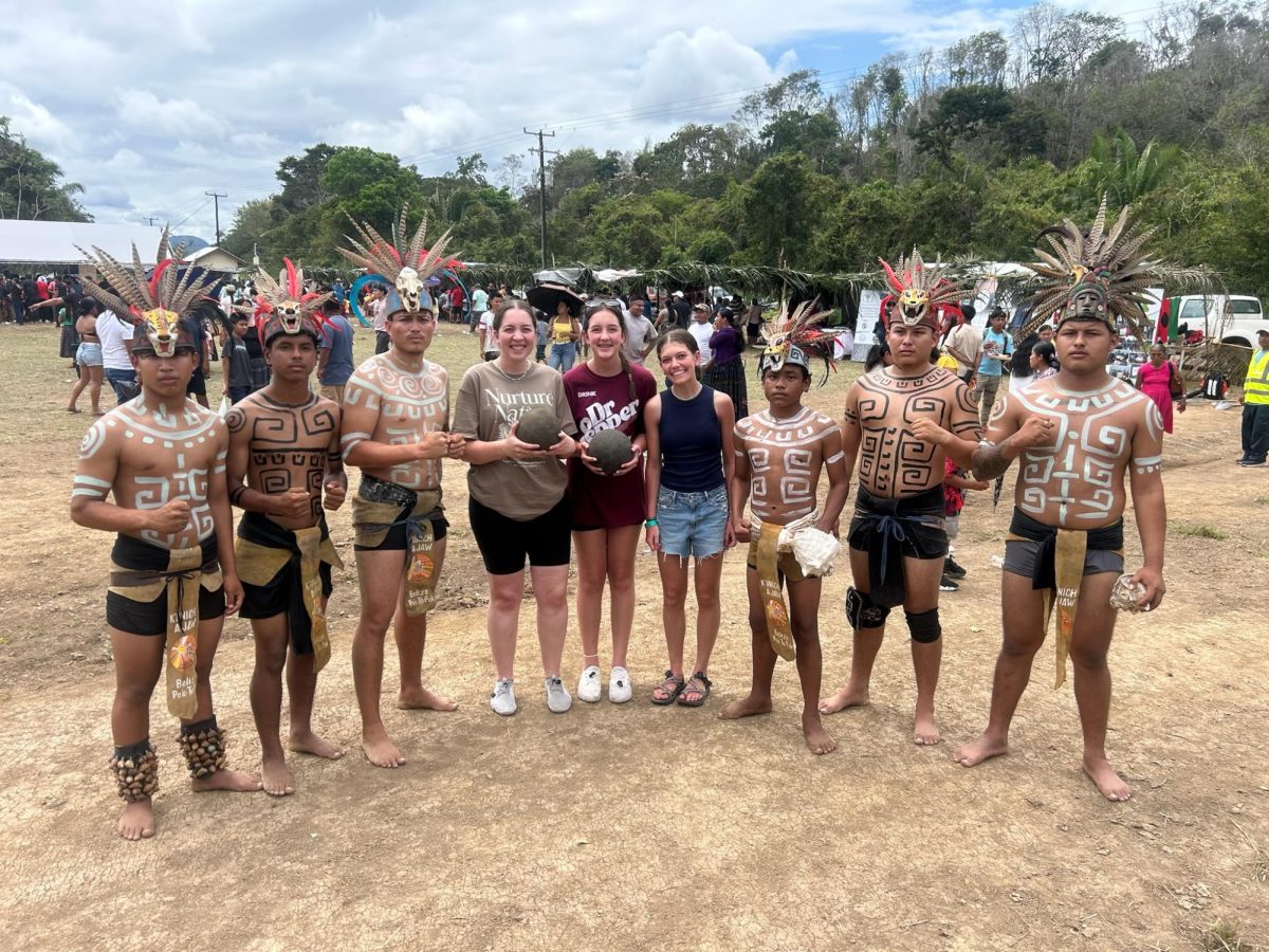 Macey Schwab poses with locals of Belize to celebrate Mayan culture and represent a sport that the Mayans used to play. "It was amazing to experience a piece of history and learn about their traditions."