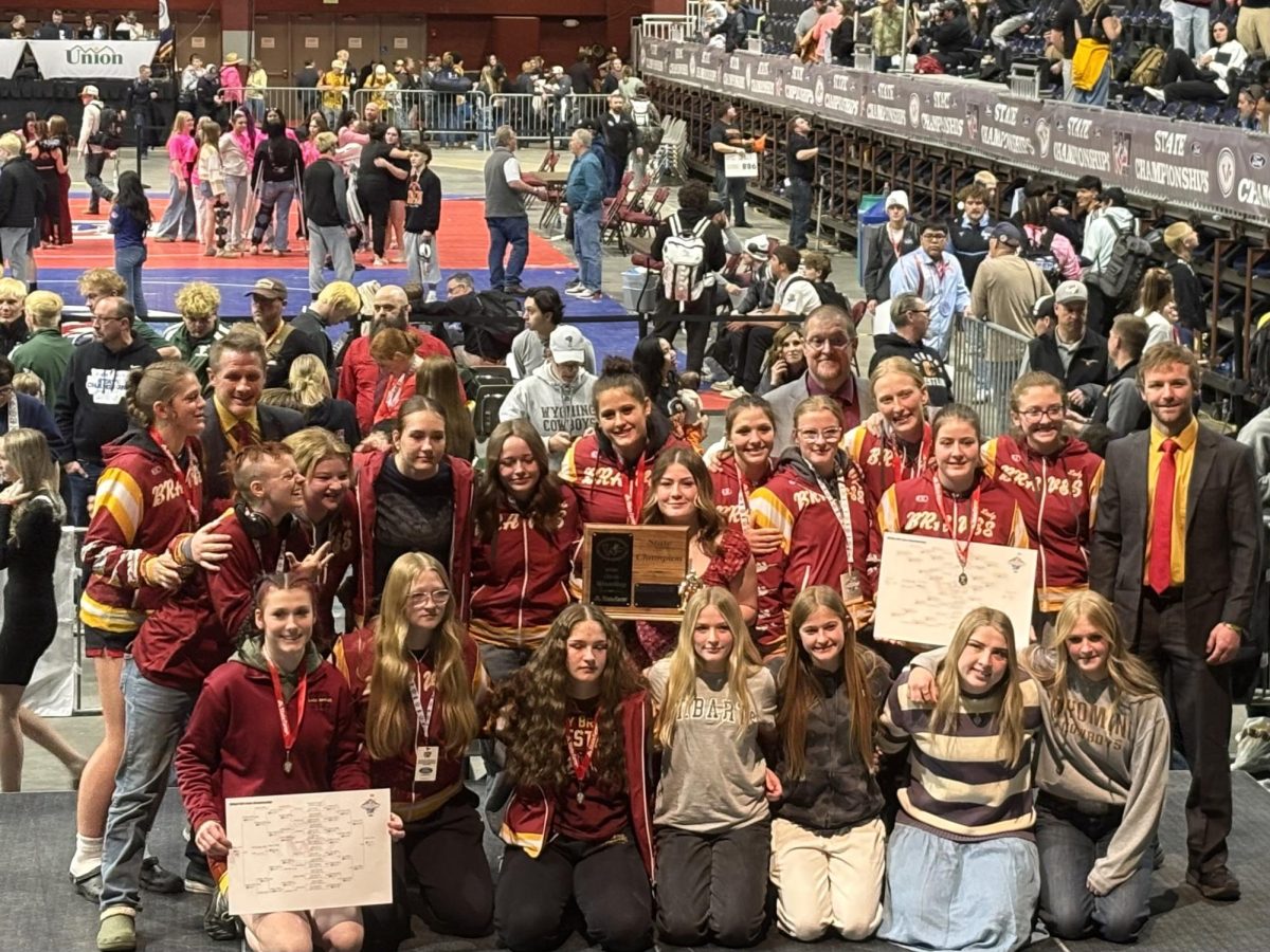 The Lady Braves pose with their team trophy. This is the fourth time in a row the team has won the state championship. Brooke Schwab said, "It's so surreal, and I'm so thankful."