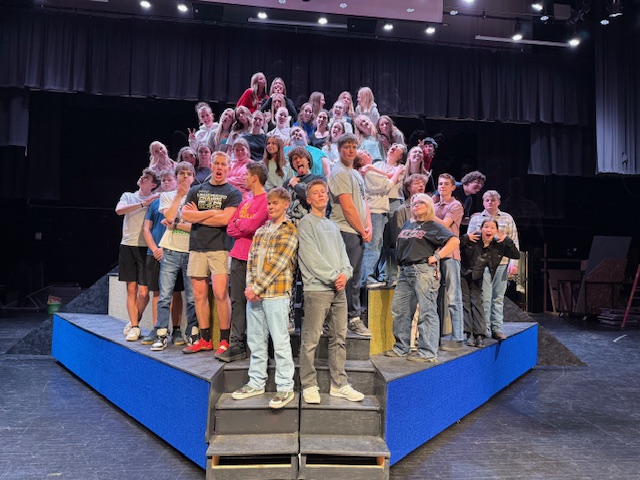 The cast rehearses together on stage at  as they prepare for opening night. Students spent weeks practicing songs, choreography, and scenes to bring the musical to life. “It’s the craziest week, but it really bonds the cast,” senior Ainsley Bowman said.