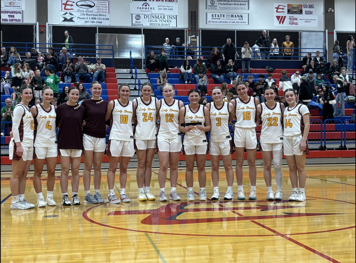 The Lady Braves pose together on the court after the regional tournament at Evanston High School. After defeating Rock Springs and Natrona, the team advanced to the championship game against Green River and finished the tournament with a second-place regional finish and a trip to the state tournament. "I'm really proud of our team for making it to state," #3 Morgan Mcgee said.